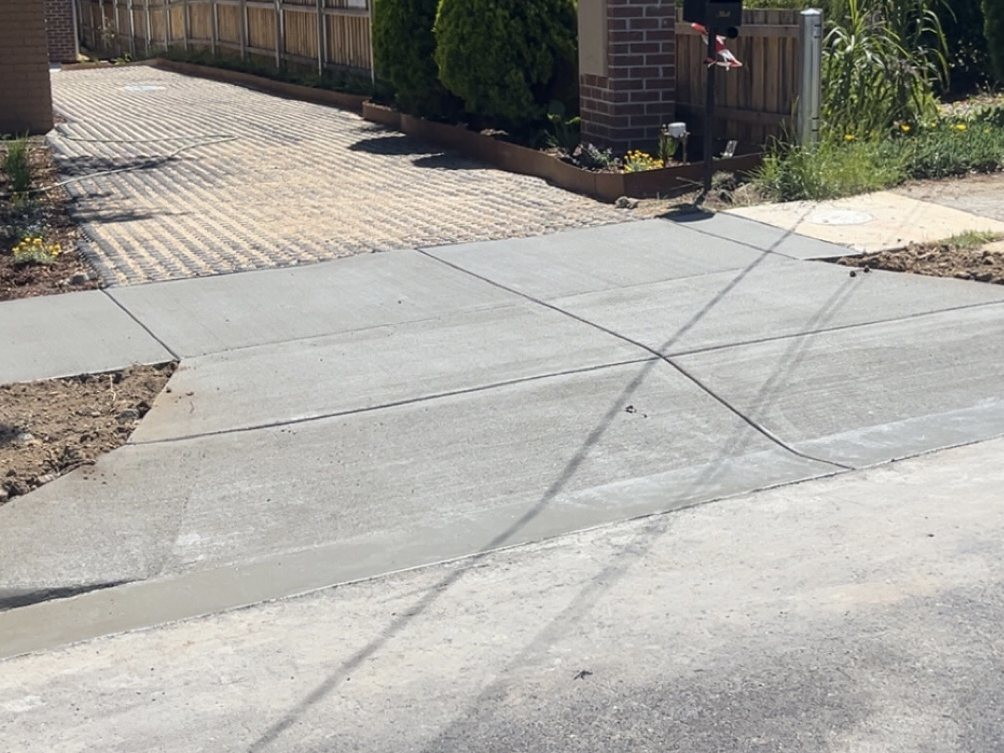 New crossover tying in to the kerb and the footpath, with the control joints cut in