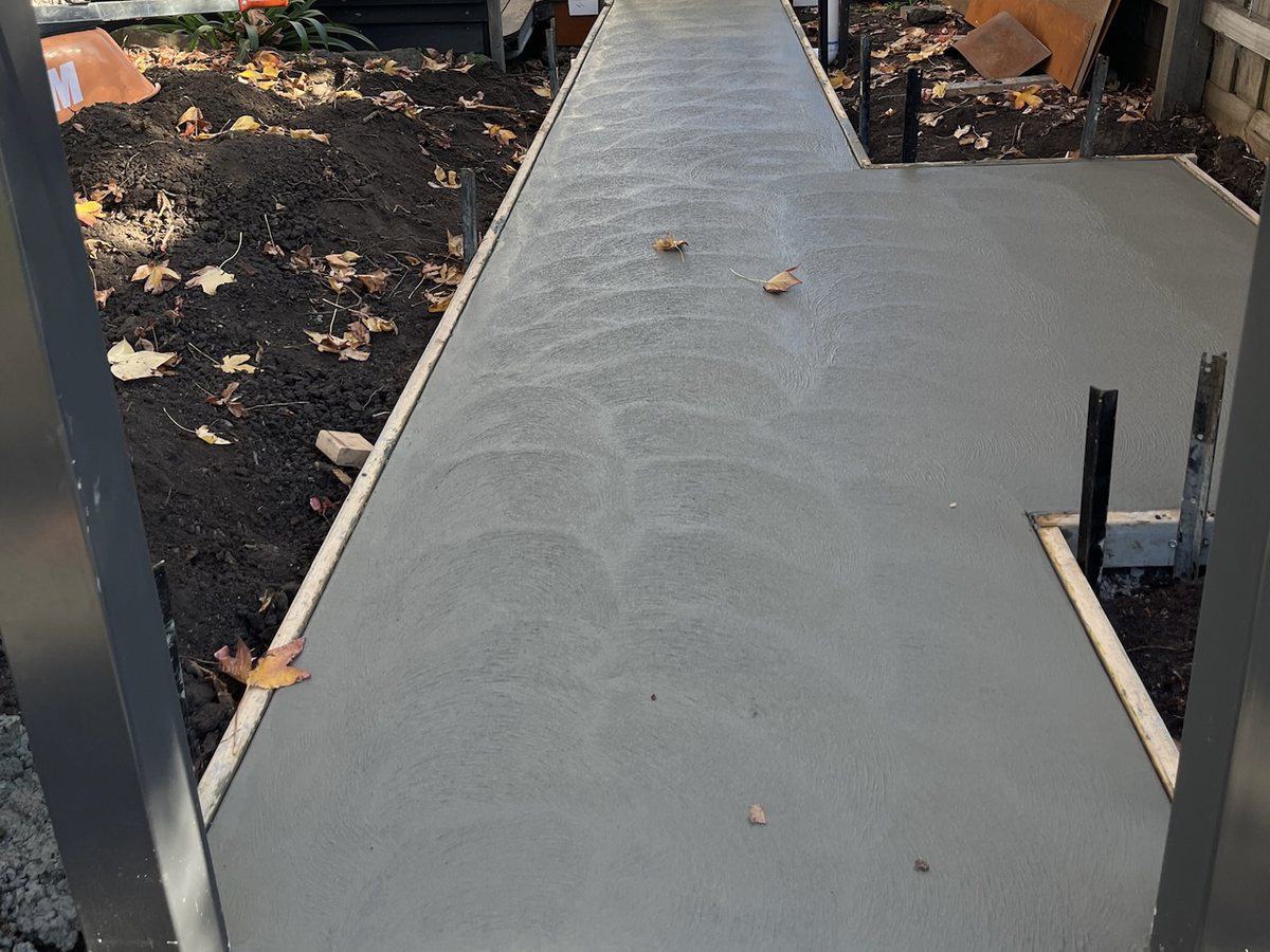 Freshly floated concrete wraparound with formwork still in place