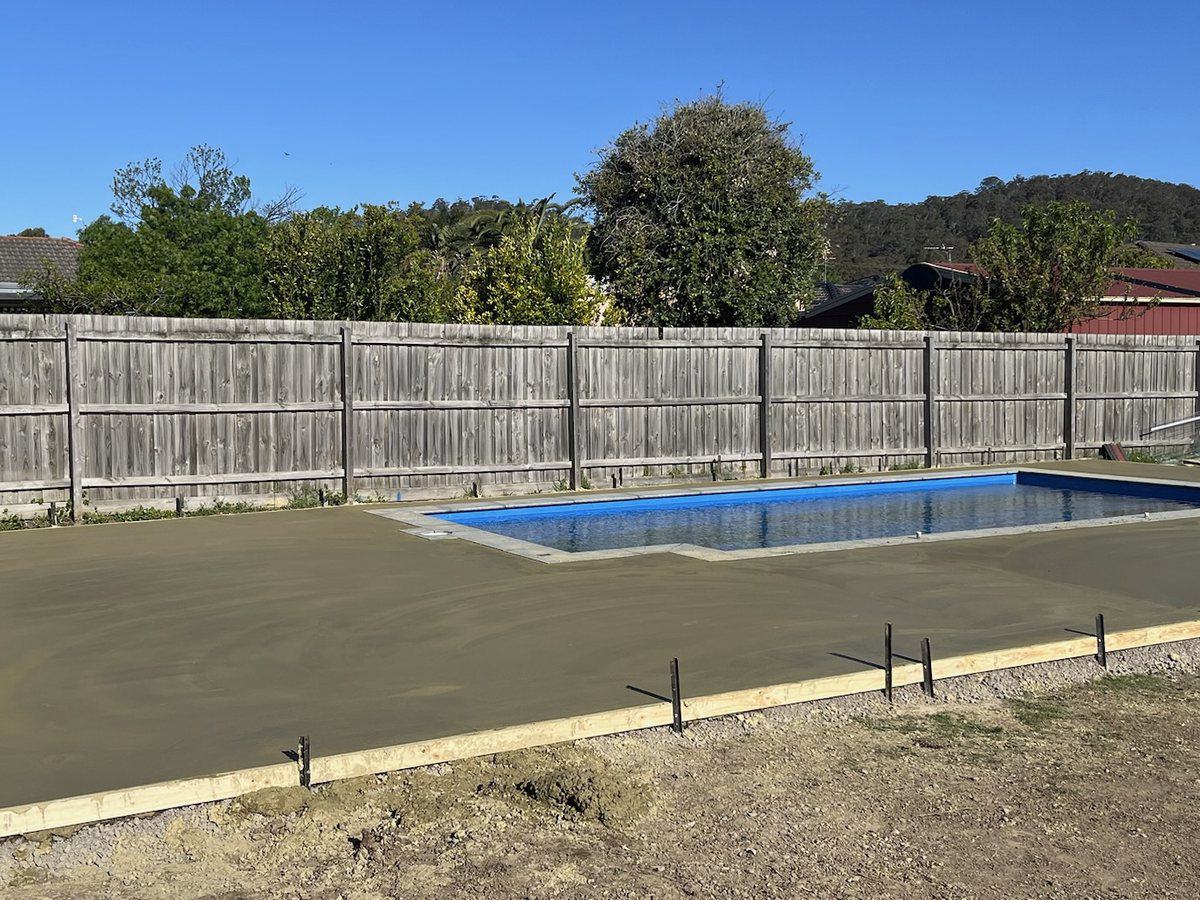 Freshly poured pool surround slab with formwork still in place